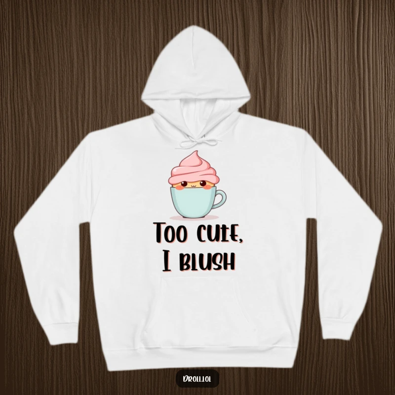 Funny blushing cupcake hiding behind a tiny coffee cup, depicted on a warm and cozy hoodie.