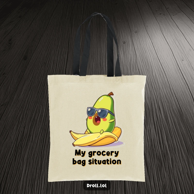 Funny tote bag featuring a surprised avocado in sunglasses slipping on a banana peel, a comical and stylish accessory for everyday use.